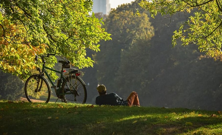 Man Lying on ground beside bicycle