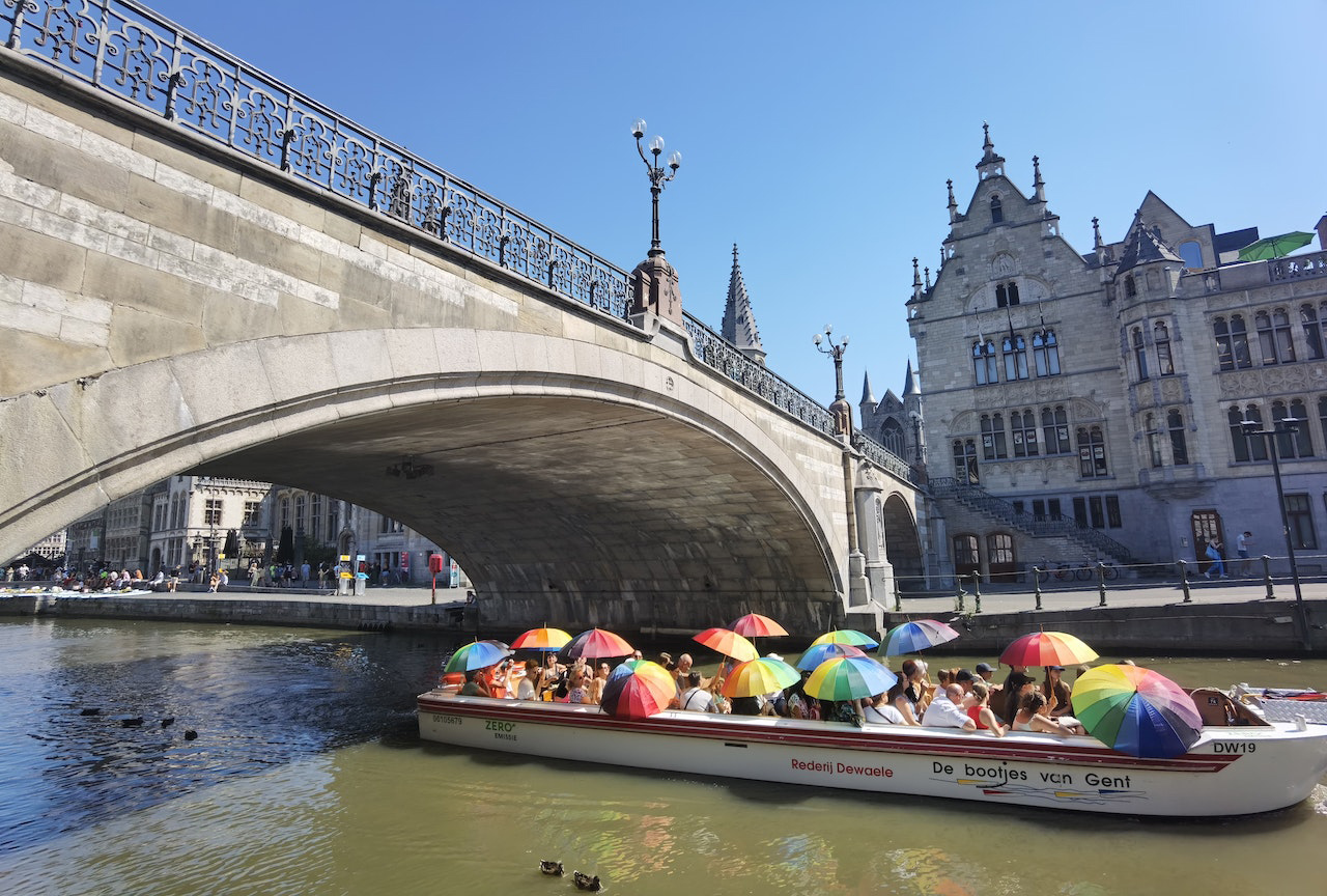 A Group of People Riding on Boat on River Under St. Michael's Bridge