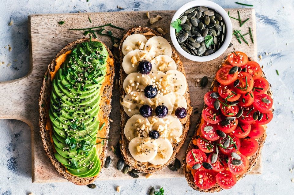 Bread toasts with avocado, banana, tomato
